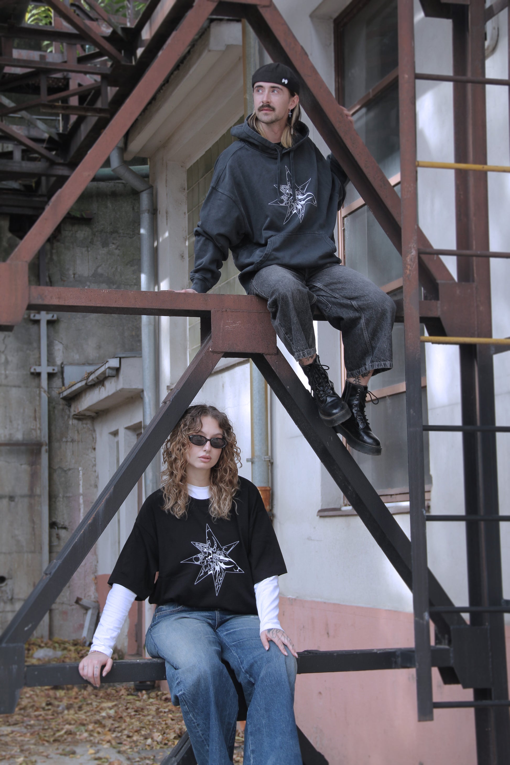 Washed-black oversized hoodie with white abstract star print on organic cotton